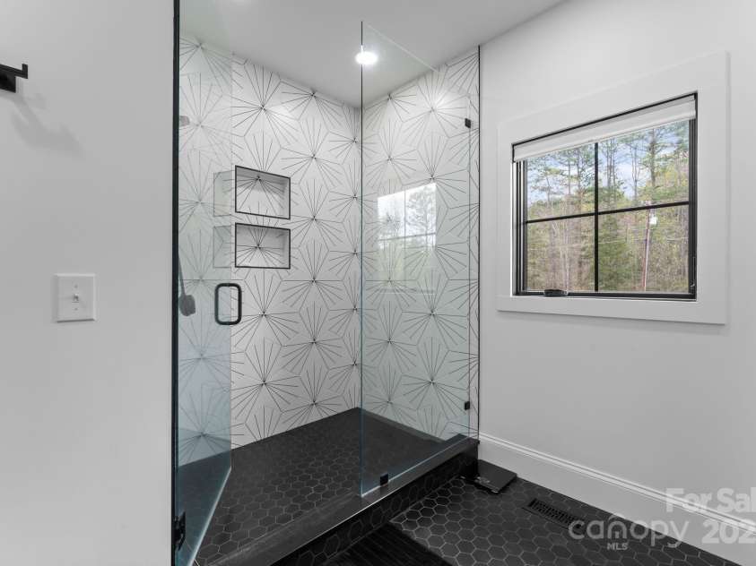 1565 Shinnville Road, Cleveland, NC 27013.  MLS# CAR4215250, YatesRealty ID 855. Main level primary bathroom with stylish tile accents