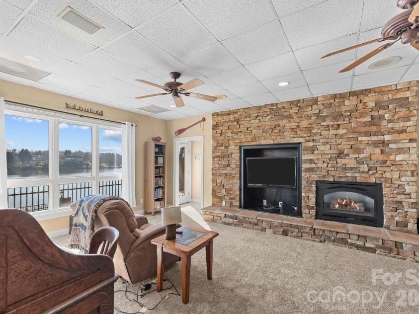 121 Pleasant Pointe Drive, Hickory, NC 28601.  MLS# CAR4327566, YatesRealty ID 8557. Basement with lake views and a gas fireplace.
