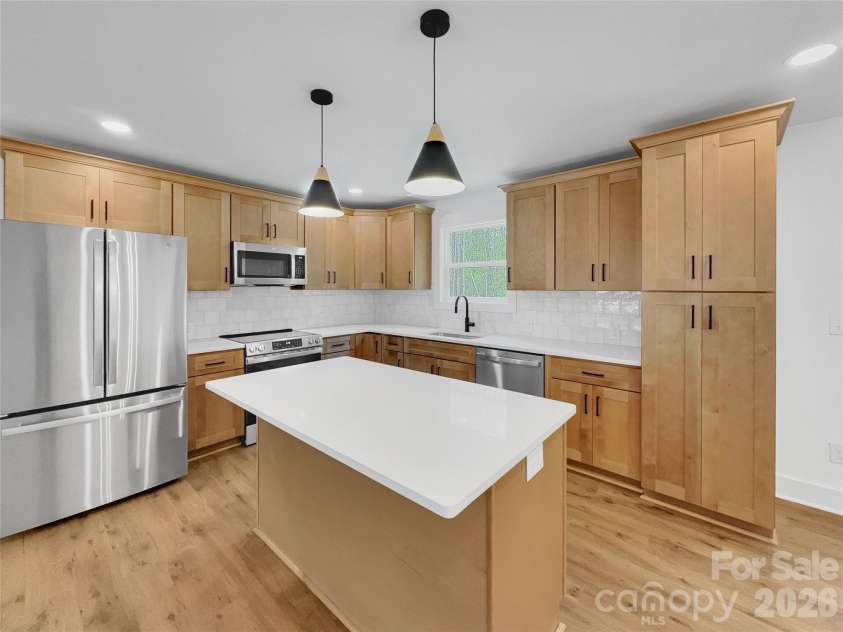 2504 Lazy Oak Drive, Lancaster, SC 29720.  MLS# CAR4357902, YatesRealty ID 8558. Beautiful kitchen with natural wood colored cabinets, quartz counters, tile backsplash, and stainless steel appliances