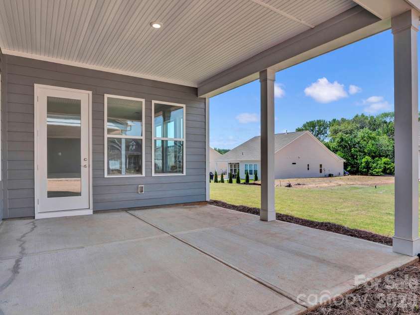 5031 Belle Mont Farm Avenue, Monroe, NC 28110.  MLS# CAR4283106, YatesRealty ID 856. Covered Lanai