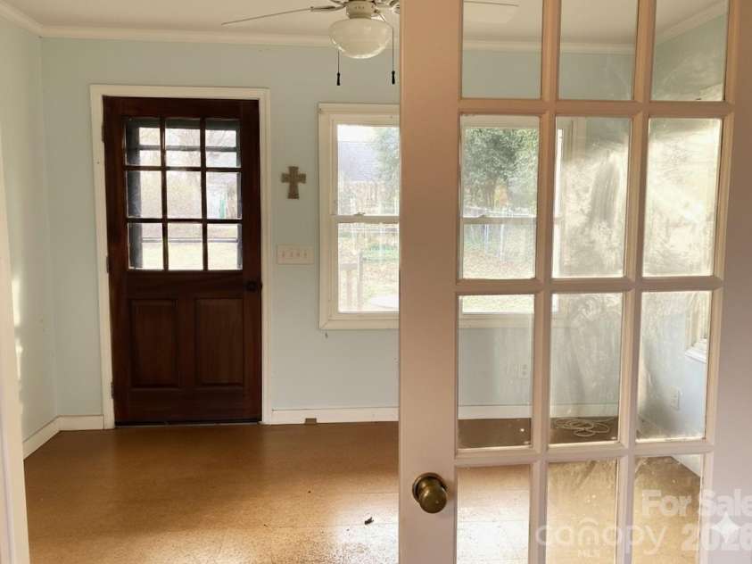 1051 Pee Dee Avenue, Albemarle, NC 28001.  MLS# CAR4328928, YatesRealty ID 8560. French doors separate a larger flex space from small living space with kitchen sink and lower cabinets.