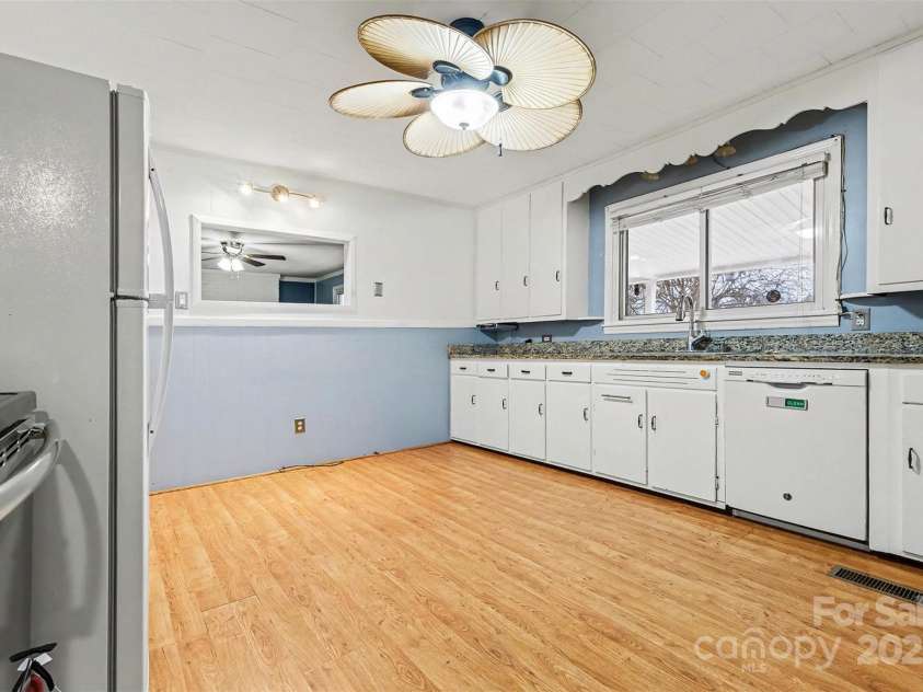 119 Moore Drive, Gastonia, NC 28056.  MLS# CAR4332115, YatesRealty ID 8565. Light-colored cabinetry and neutral finishes create a bright, inviting feel, while a large window over the sink provides natural light.