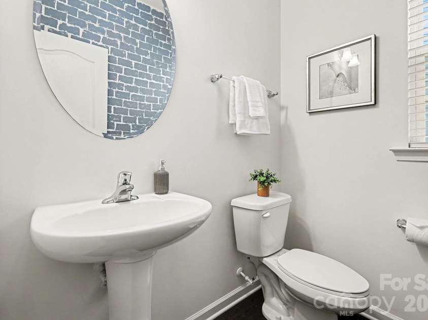 6056 Cloverdale Drive, Tega Cay, SC 29708.  MLS# CAR4337885, YatesRealty ID 8573. Half bath with custom accent wall on the main level - perfect for guests!