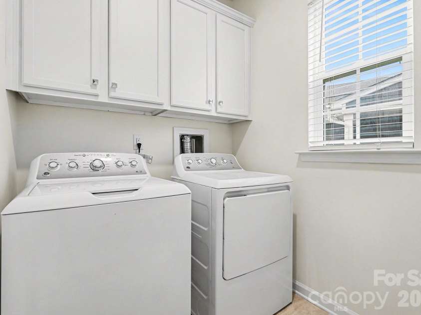 6056 Cloverdale Drive, Tega Cay, SC 29708.  MLS# CAR4337885, YatesRealty ID 8573. Laundry room on the main level with cabinetry