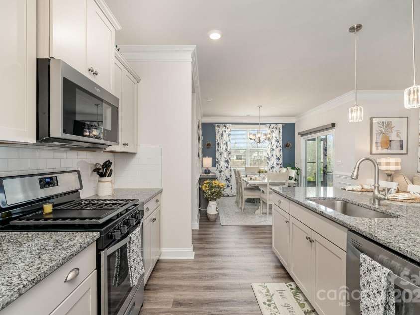 4023 Gozzi Drive, Iron Station, NC 28080.  MLS# CAR4223127, YatesRealty ID 8588. Gas stove with griddle and beautiful pendant lighting above the large kitchen island