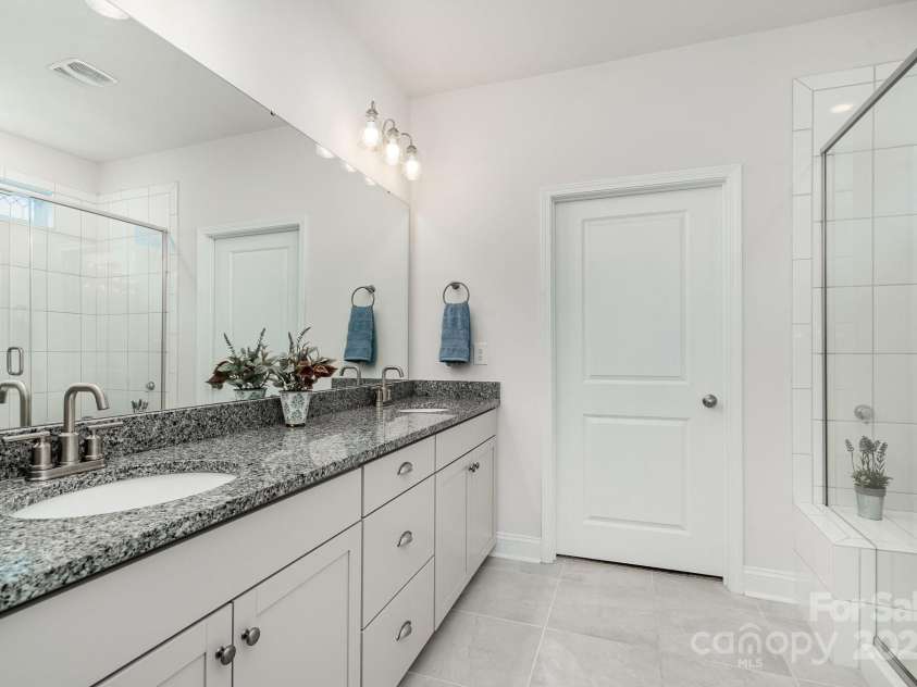 4023 Gozzi Drive, Iron Station, NC 28080.  MLS# CAR4223127, YatesRealty ID 8588. The primary bath features a generous walk-in closet which also leads to the laundry room!