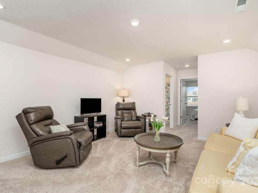 4023 Gozzi Drive, Iron Station, NC 28080.  MLS# CAR4223127, YatesRealty ID 8588. Upstairs family room is tucked back from the stairs, giving privacy and additionals space for entertaining or guests