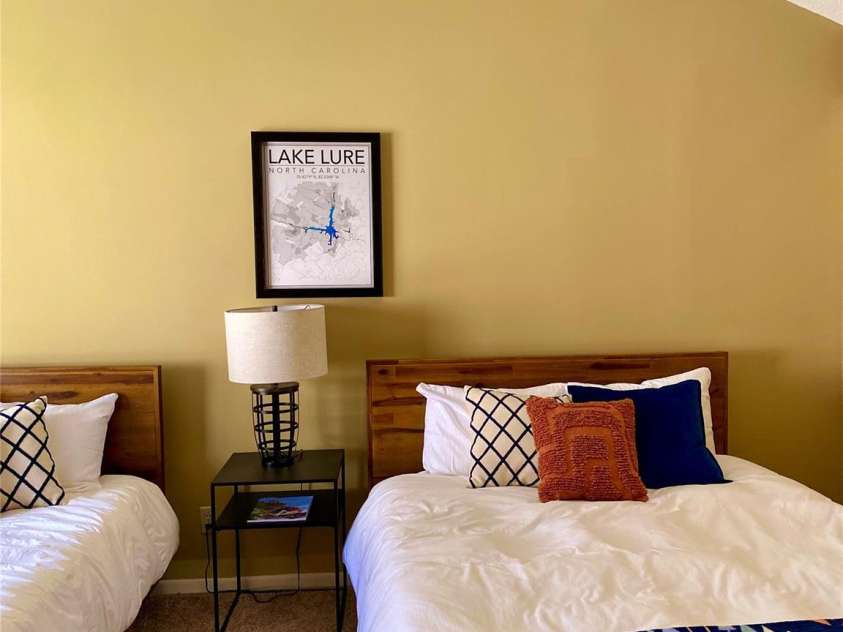 135 Fox Run Boulevard, Lake Lure, NC 28746.  MLS# CAR4226040, YatesRealty ID 8591. Huge upstairs bedrooms with two queen beds, vaulted ceilings and deck off the back