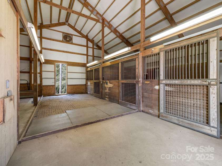 177 Fowler Road, Mill Spring, NC 28756.  MLS# CAR4249050, YatesRealty ID 8594. The Morton barn features a wide aisle, 3 stalls, a tack room and storage area, hot and cold water.