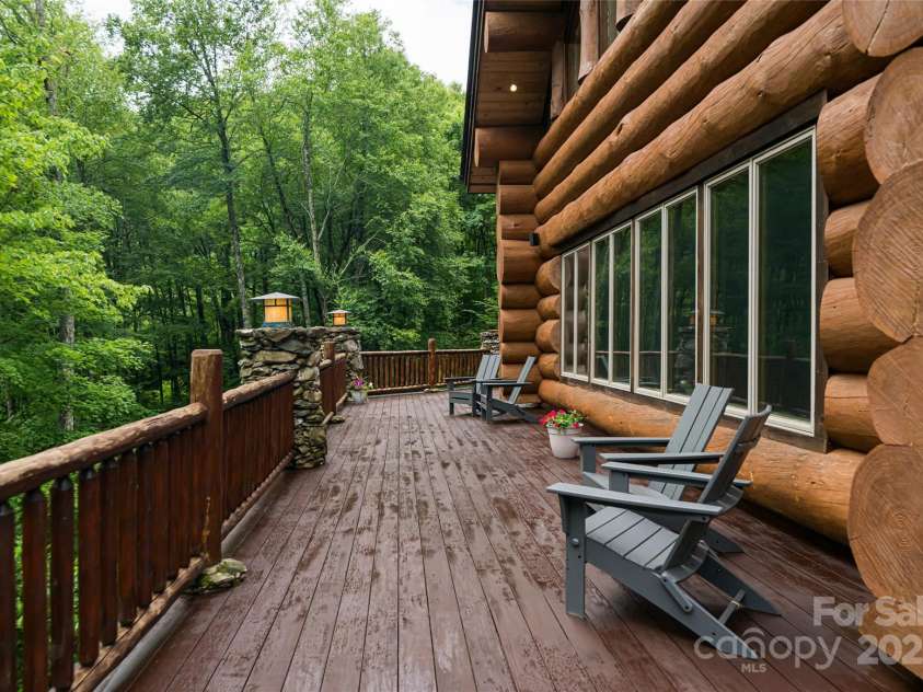 303 Flying Hawk Trail, Waynesville, NC 28786.  MLS# CAR4272138, YatesRealty ID 86. Immense Main level deck offers ample space to enjoy the lush park like setting