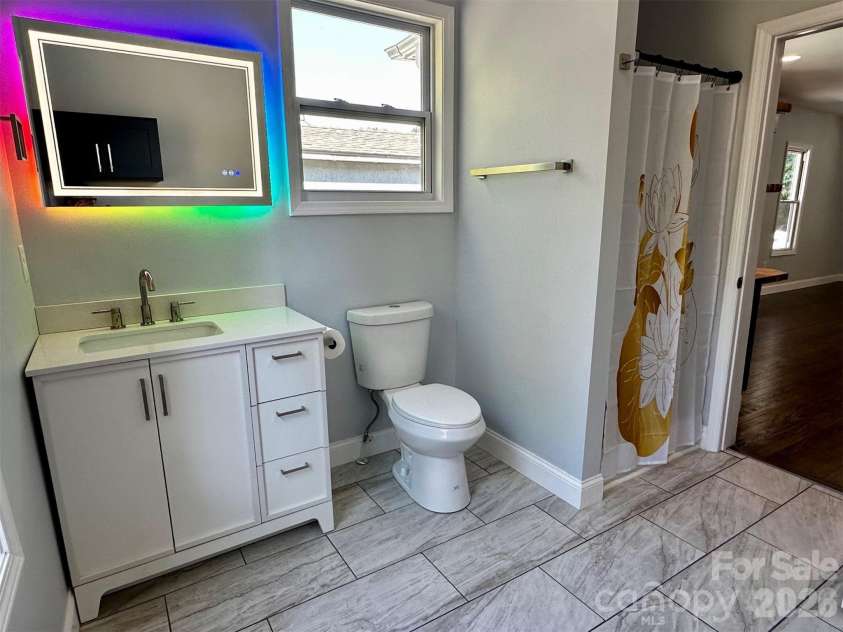 11 Martel Lane, Asheville, NC 28804.  MLS# CAR4304470, YatesRealty ID 8611. Fun Mirror in Guest Bathroom/Laundry