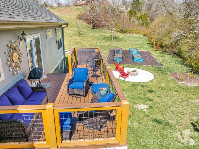 223 Reilly Drive, Leicester, NC 28748.  MLS# CAR4353690, YatesRealty ID 8619. Back deck, fire pit, and raised beds!