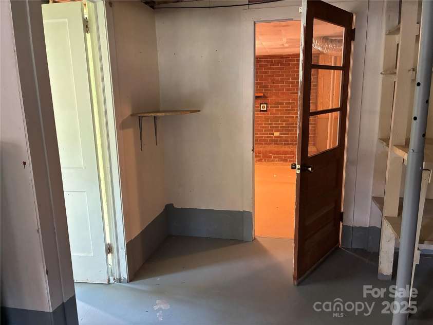 107 Mull Lane, Morganton, NC 28655.  MLS# CAR4225575, YatesRealty ID 8631. Entrance of basement with shower to left, entrance to bonus room straight ahead