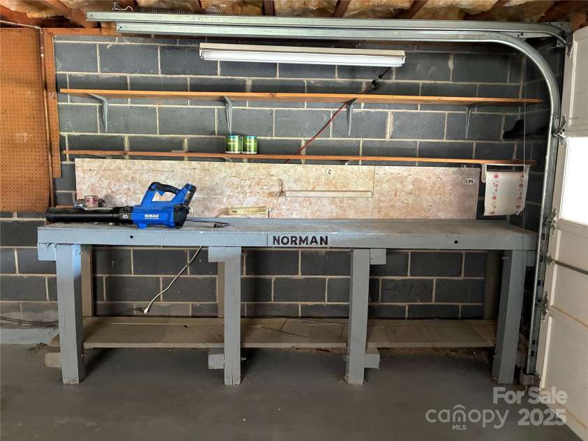 107 Mull Lane, Morganton, NC 28655.  MLS# CAR4225575, YatesRealty ID 8631. Workbench beside garage door