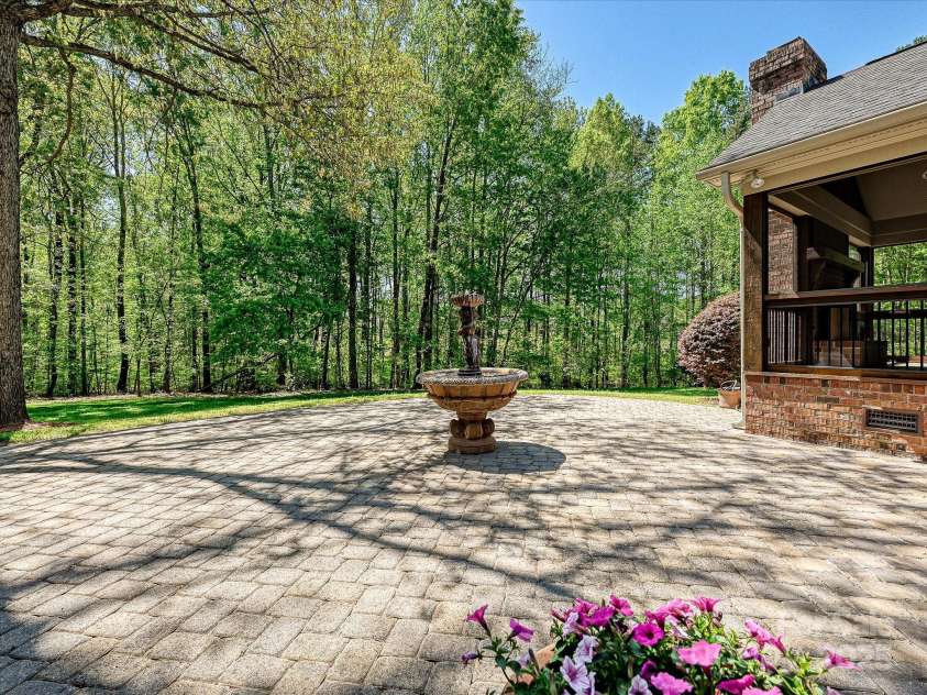 1413 Willow Oaks Trail, Weddington, NC 28104.  MLS# CAR4244521, YatesRealty ID 8632. Back patio with fountain