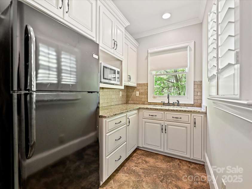 1413 Willow Oaks Trail, Weddington, NC 28104.  MLS# CAR4244521, YatesRealty ID 8632. Kitchenette in guest suite/2nd living qtrs.