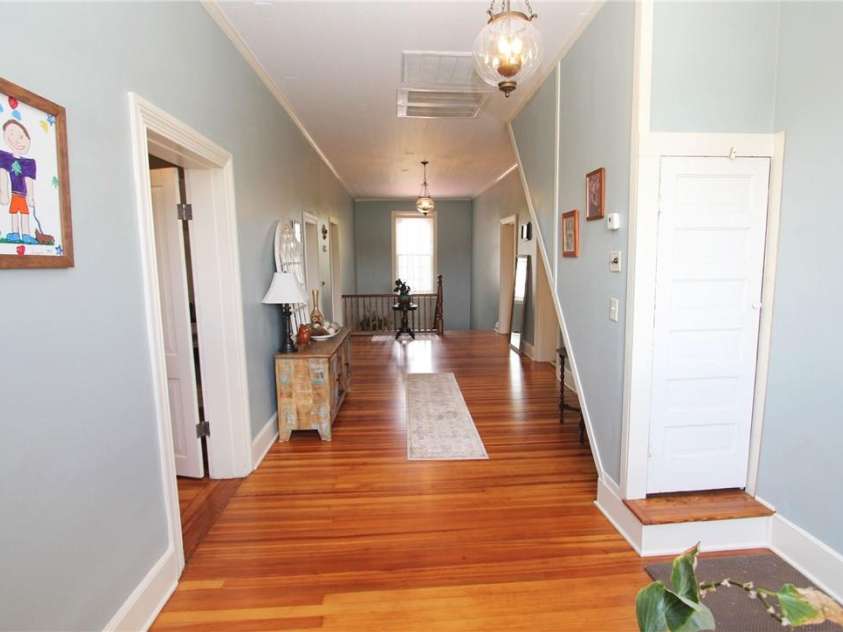 318 Camden Road, Wadesboro, NC 28170.  MLS# CAR3904497, YatesRealty ID 865. UPSTAIRS HALLWAY,  DOOR WITH PERMANENT STEPS TO ATTIC STORAGE