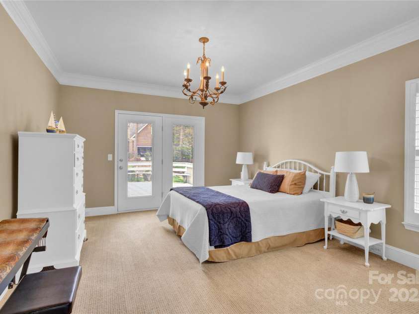 105 Beach Lane, Mooresville, NC 28117.  MLS# CAR4240933, YatesRealty ID 8681. Primary bedroom leading out to deck area