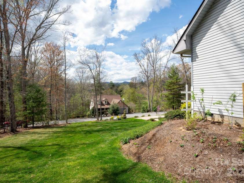 19 Dynasty Lane, Candler, NC 28715.  MLS# CAR4243539, YatesRealty ID 8687. Well-Kept Lawn and Owner-Planted Berry Patch
