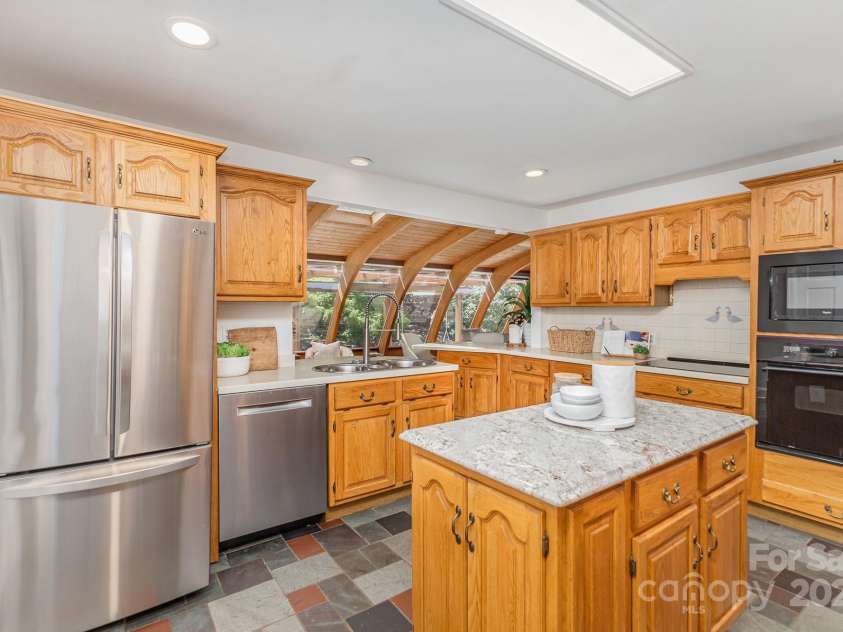 3916 Riverbend Road, Charlotte, NC 28210.  MLS# CAR4241946, YatesRealty ID 8693. Kitchen looking into sunroom