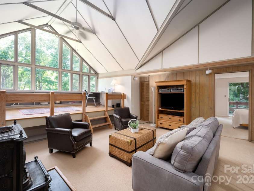 552 Avery Creek, Arden, NC 28704.  MLS# CAR4162380, YatesRealty ID 8706. Upstairs Loft Sitting Area with Wood-Burning Stove