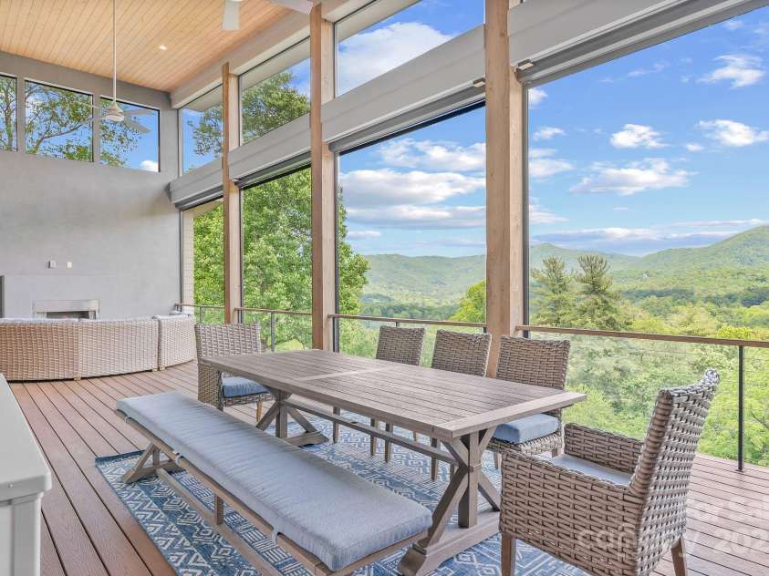 34 Grovepoint Way, Asheville, NC 28804.  MLS# CAR4228655, YatesRealty ID 8710. Covered outdoor living space with grilling and seating areas.