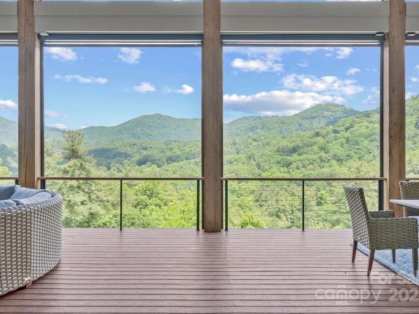 34 Grovepoint Way, Asheville, NC 28804.  MLS# CAR4228655, YatesRealty ID 8710. Covered outdoor living space with grilling and seating areas.