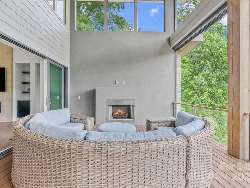 34 Grovepoint Way, Asheville, NC 28804.  MLS# CAR4228655, YatesRealty ID 8710. Covered outdoor living space with grilling and seating areas.