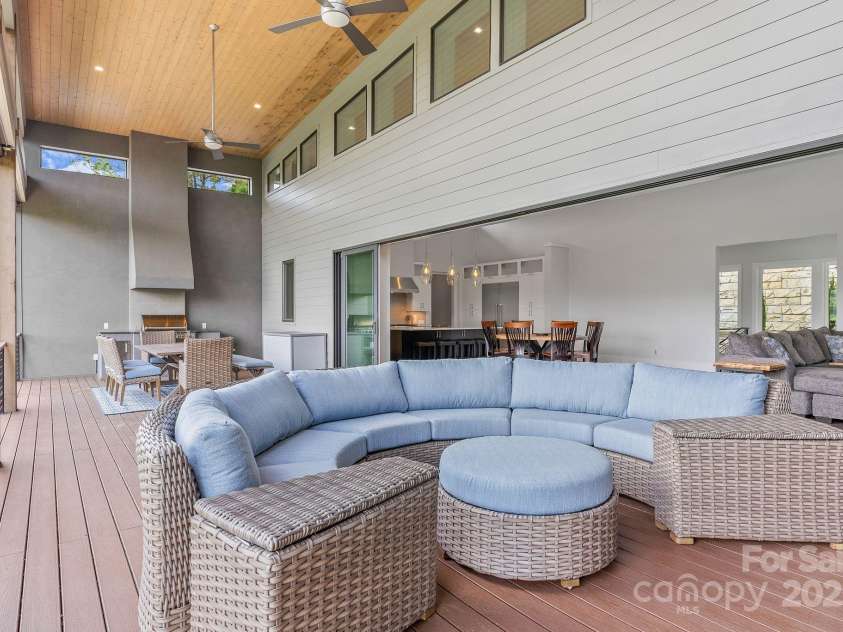 34 Grovepoint Way, Asheville, NC 28804.  MLS# CAR4228655, YatesRealty ID 8710. Covered outdoor living space with grilling and seating areas.