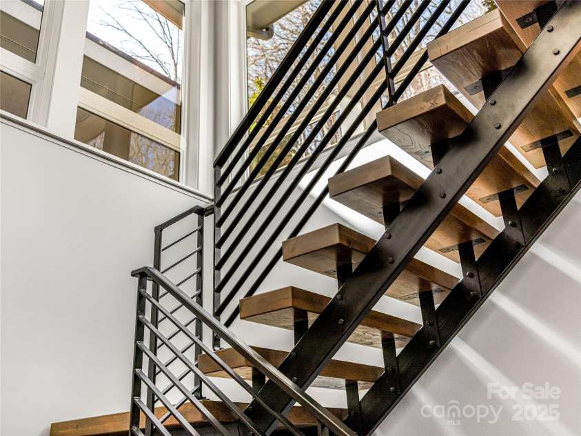 34 Grovepoint Way, Asheville, NC 28804.  MLS# CAR4228655, YatesRealty ID 8710. Industrial Modern floating staircase to lower area.