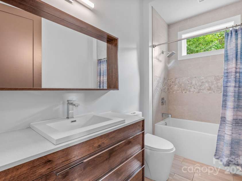 34 Grovepoint Way, Asheville, NC 28804.  MLS# CAR4228655, YatesRealty ID 8710. Lower level en suite bathroom.