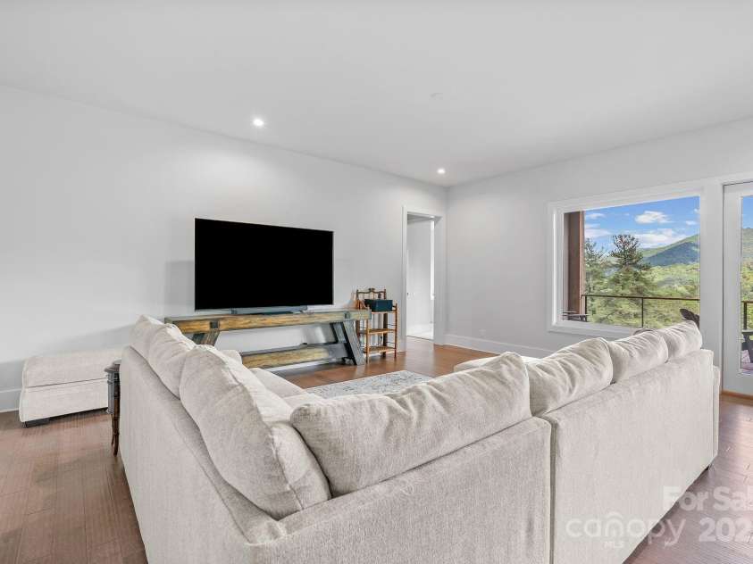 34 Grovepoint Way, Asheville, NC 28804.  MLS# CAR4228655, YatesRealty ID 8710. Lower level living room view.