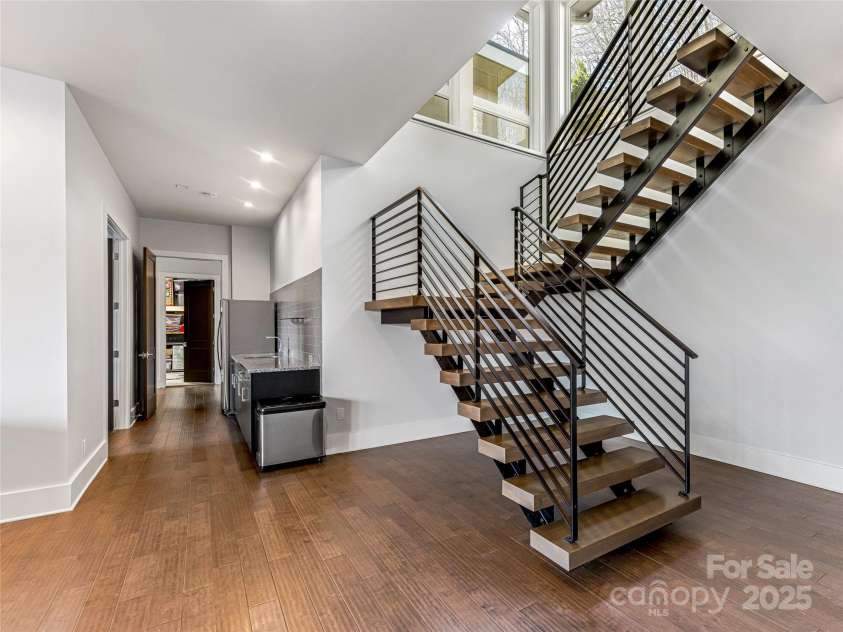 34 Grovepoint Way, Asheville, NC 28804.  MLS# CAR4228655, YatesRealty ID 8710. Staircase with lower level kitchen and bar area.