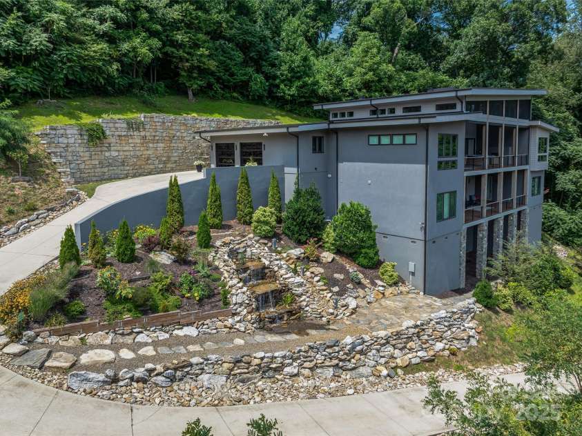 34 Grovepoint Way, Asheville, NC 28804.  MLS# CAR4228655, YatesRealty ID 8710. The home is set privately above the street with exceptional mountain views.