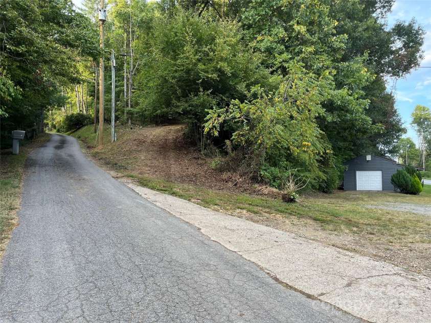 1961 Cane Creek Road, Fletcher, NC 28732.  MLS# CAR4233282, YatesRealty ID 8722. Road thru property to private homesite