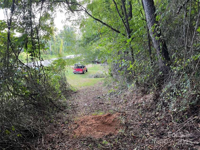 1961 Cane Creek Road, Fletcher, NC 28732.  MLS# CAR4233282, YatesRealty ID 8722. Road to second homesite