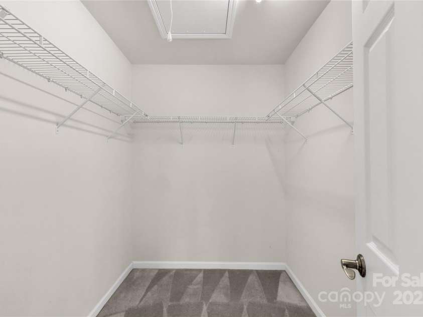 3411 Xandra Court, Indian Land, SC 29707.  MLS# CAR4242708, YatesRealty ID 8725. Large primary closet with pull down attic stairs