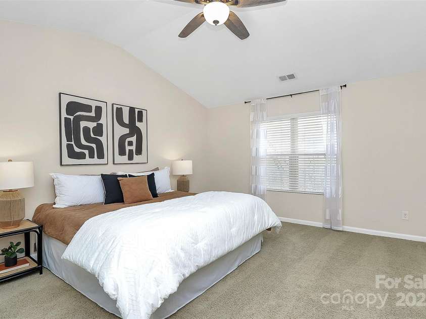 137 Woodbridge Circle, Mount Holly, NC 28120.  MLS# CAR4222548, YatesRealty ID 8731. Large primary bedroom suite with gorgeous vaulted ceilings, facing private woods - new carpet & fresh paint!