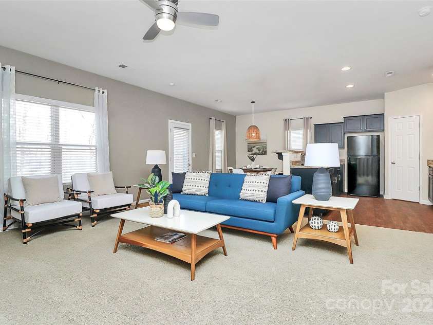137 Woodbridge Circle, Mount Holly, NC 28120.  MLS# CAR4222548, YatesRealty ID 8731. Living room view showing open flow to kitchen & dining area.
