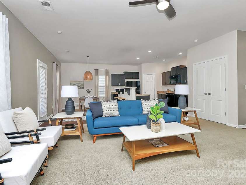 137 Woodbridge Circle, Mount Holly, NC 28120.  MLS# CAR4222548, YatesRealty ID 8731. Living room view showing open flow to kitchen & dining area, as well as downstairs storage closet.