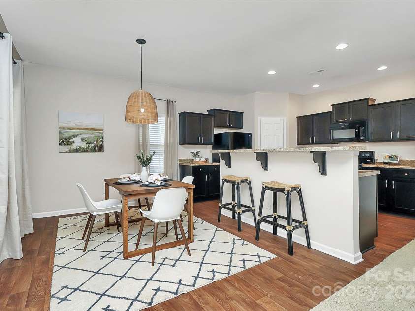 137 Woodbridge Circle, Mount Holly, NC 28120.  MLS# CAR4222548, YatesRealty ID 8731. Open dining/kitchen space with transition via bar area suitable for plenty of guests.