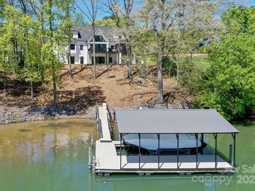 153 High Hills Drive, Mooresville, NC 28117.  MLS# CAR4246842, YatesRealty ID 8735. Waterfront home w/ private boat dock, covered boat slip, & 2 lifts