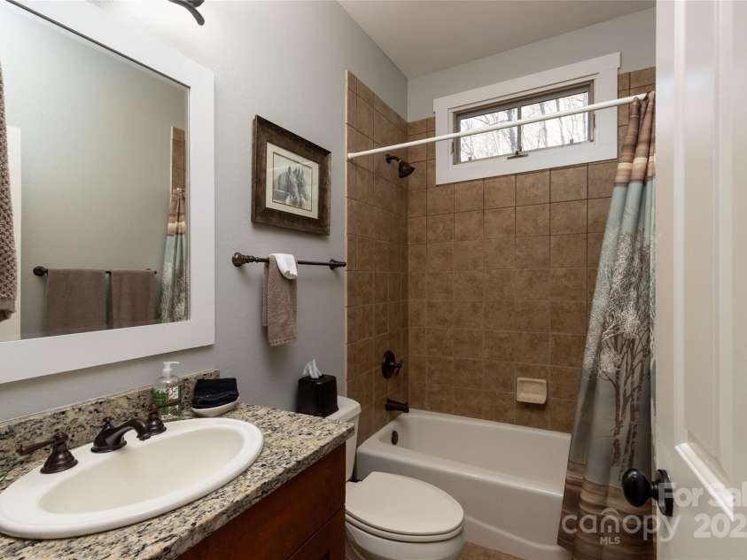 126 Mossycup Court, Tuckasegee, NC 28783.  MLS# CAR4324867, YatesRealty ID 874. Hall/Guest Bathroom, Granite vanity - Full tiled tub/shower.