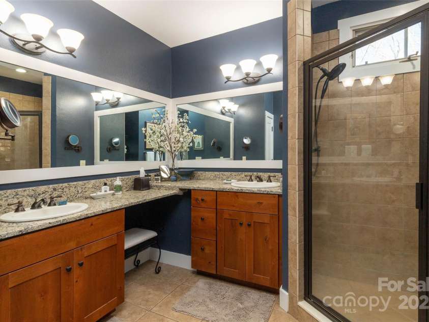 126 Mossycup Court, Tuckasegee, NC 28783.  MLS# CAR4324867, YatesRealty ID 874. Primary Bathroom with tall countertops and walk in tile shower. 