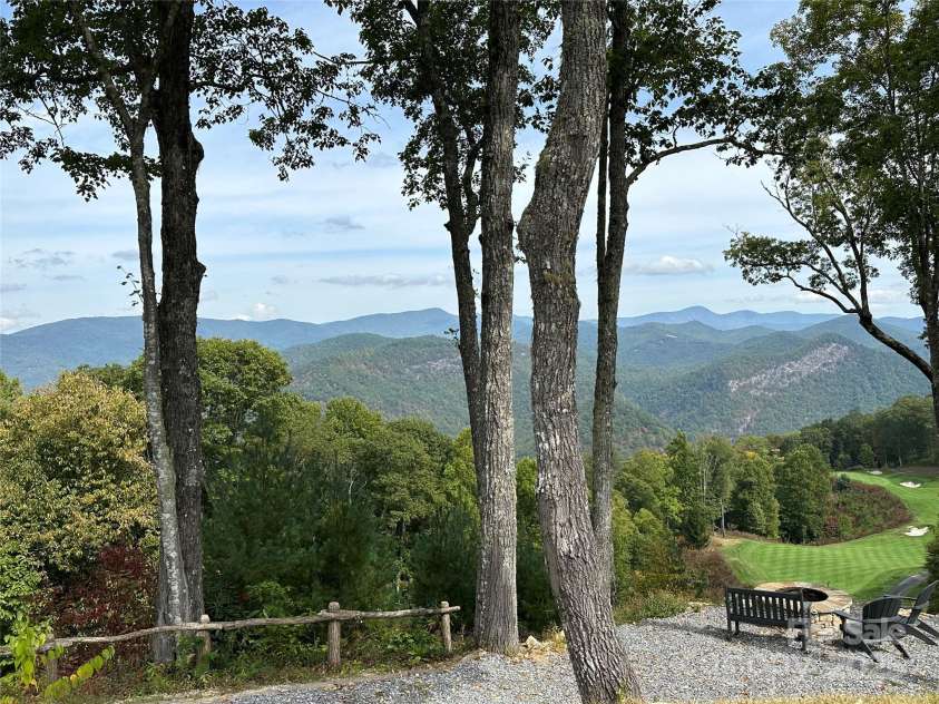 126 Mossycup Court, Tuckasegee, NC 28783.  MLS# CAR4324867, YatesRealty ID 874. Views over Hole #1 - Relax by the Fire Pit