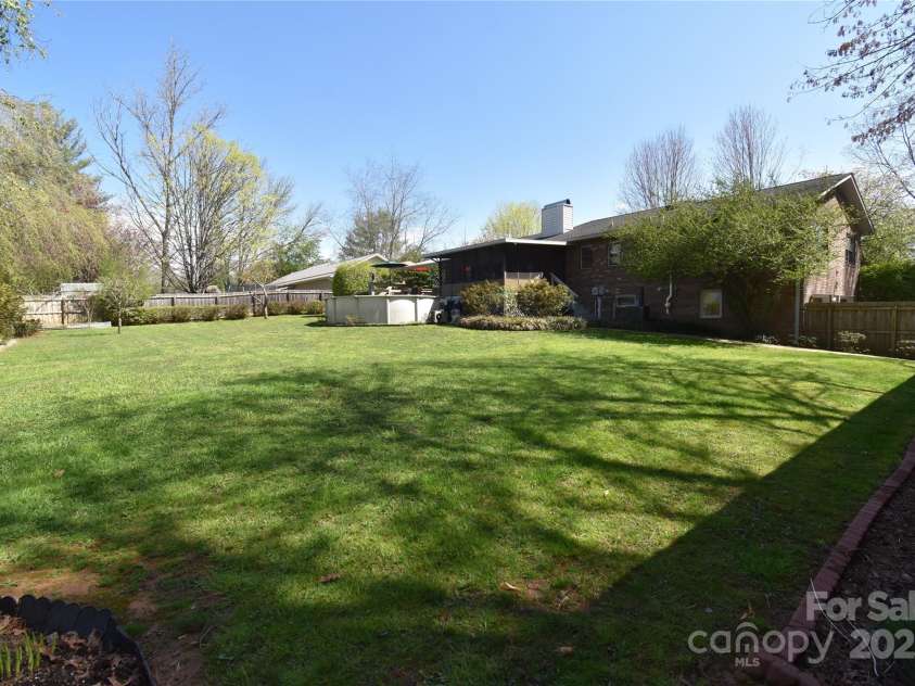 37 Hillside Drive, Etowah, NC 28729.  MLS# CAR4243156, YatesRealty ID 8761. Backyard standing at rear of workshop