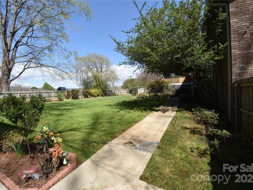 37 Hillside Drive, Etowah, NC 28729.  MLS# CAR4243156, YatesRealty ID 8761. Walkway from workshop to back yard