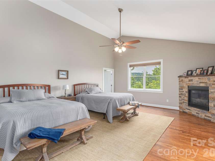 930 Big Raven Lane, Saluda, NC 28773.  MLS# CAR4270163, YatesRealty ID 8761. The primary suite has a gas fireplace for staying cozy during the winter months