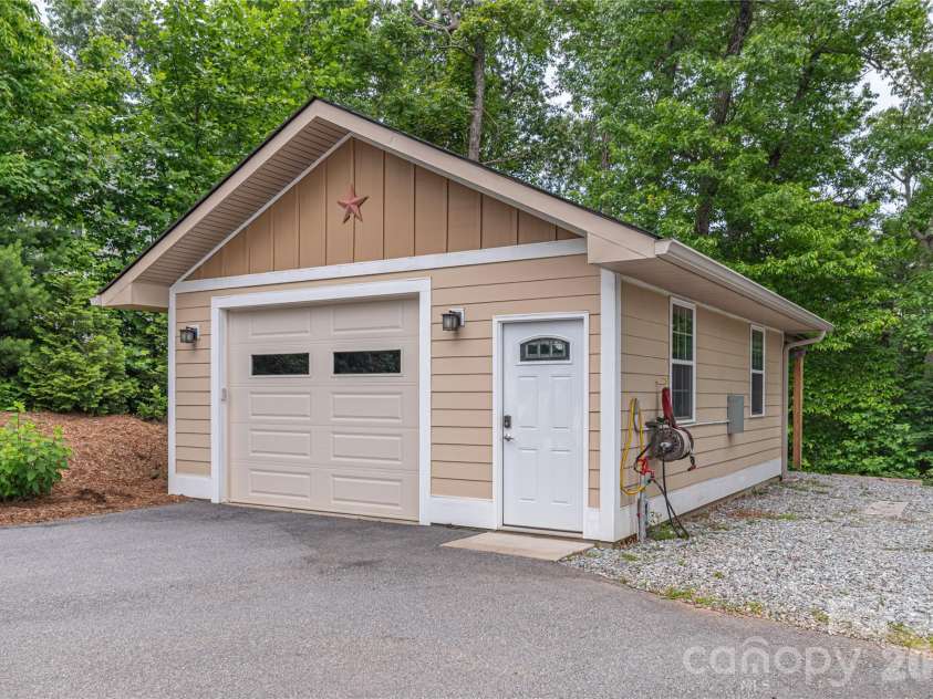 930 Big Raven Lane, Saluda, NC 28773.  MLS# CAR4270163, YatesRealty ID 8761. This detached garage offers heat from its own propane tank, a mini fridge, and multiple RV hook ups