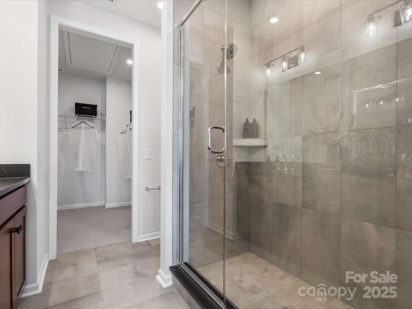5516 Swaling Street, Charlotte, NC 28217.  MLS# CAR4318946, YatesRealty ID 8768. Primary Walk-In Shower with Modern Tile Design. *Model Photos | Actual Finishes, Structural Selections, and Orientation May Vary.